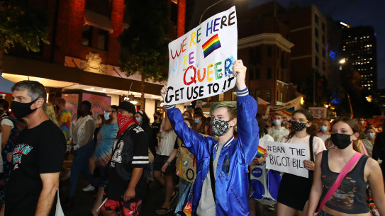 BRISBANE, AUSTRALIA - FEBRUARY 04: Protestors march as they hold signs during a rally against the Religious Discrimination Bill on February 04, 2022 in Brisbane, Australia. Activists gathered to protest discrimination after Citipointe Christian College asked its students to sign an enrolment contract agreeing to their biological gender and denouncing homosexuality. The principal retracted the policy and apologised but some continue to call for his resignation. (Photo by Jono Searle/Getty Images)