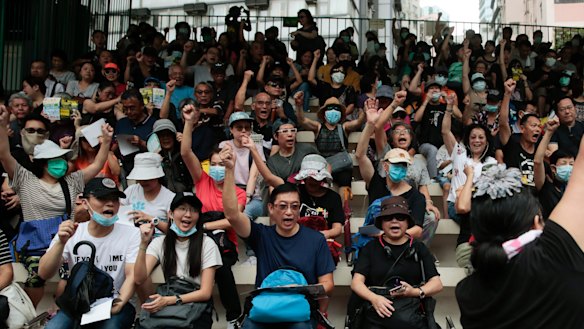 Protesters pumped their fists as they chanted slogans in the stands of the soccer field at Southorn Playground in Wan Chai, Hong Kong.