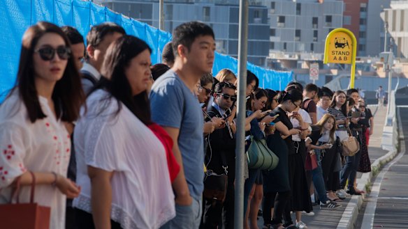 Commuters wait for the free shuttle at Wentworth Point.