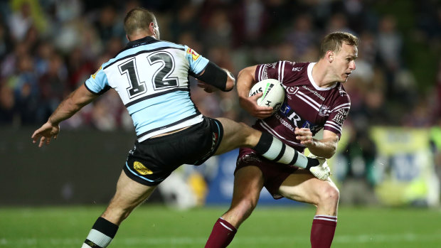 Leg over: Wade Graham tries an unusual approach to stopping Daly Cherry-Evans.