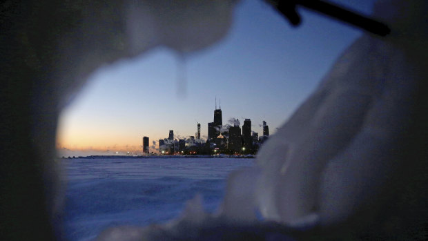 Ice forms along the shore of Lake Michigan in Chicago before sunrise on Thursday.