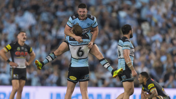 Up, up Cronulla: Chad Townsend jumps into the arms of Matt Moylan after the Sharks' victory.