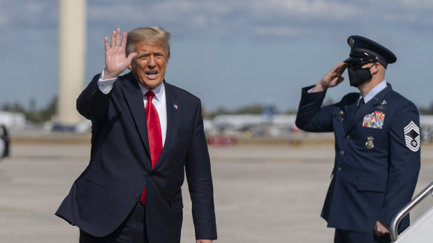 Donald Trump waves to the media after his final flight on Air Force One at Palm Beach International Airport in Florida.