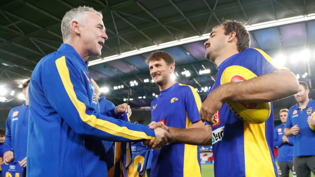 Simpson presents Aaron Black with his guernsey before his debut game for West Coast.