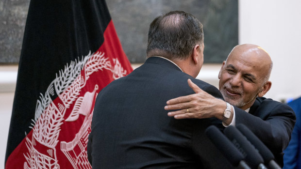 Afghan President Ashraf Ghani, right, and Secretary of State Mike Pompeo, left, hug following a news conference at the Presidential Palace in Kabul, Afghanistan, on July  9.