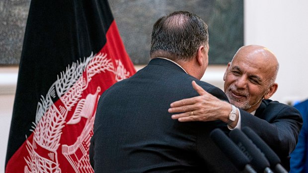 Afghan President Ashraf Ghani, right, and Secretary of State Mike Pompeo, left, hug following a news conference at the Presidential Palace in Kabul, Afghanistan, on July  9.