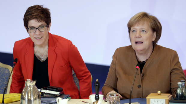 German Chancellor and CDU chairwoman Angela Merkel, right, and the party's Secretary General, Annegret Kramp-Karrenbauer attend a board meeting prior to the vote.