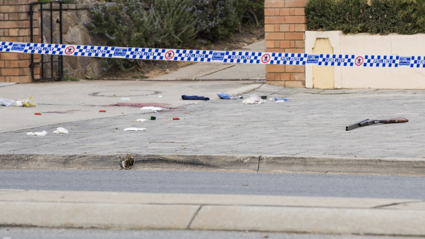 A shotgun lies on a Queanbeyan street where an armed man was shot by police on Saturday morning.