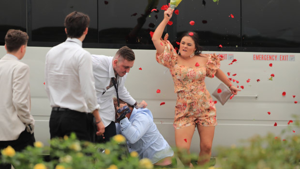 Blooming disgrace: A woman hits two brawlers with a bunch of roses.