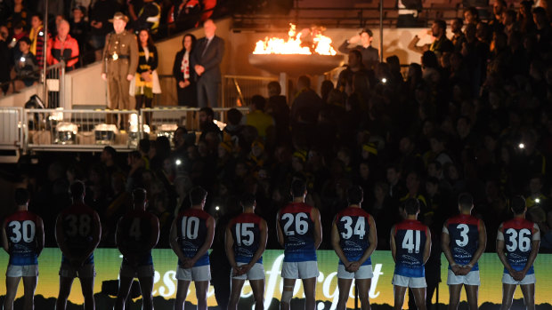 Before the bounce: Melbourne players during the ANZAC pre-game ceremony.