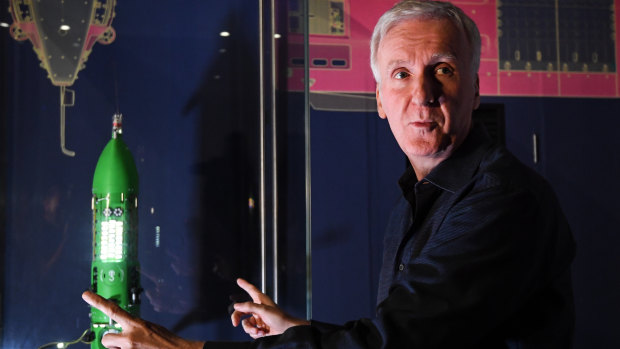 James Cameron poses for a photo with a scale model of the Deepsea Challenger at the Australian National Maritime Museum in Sydney on Monday. 