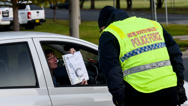 A person wishing to cross the border on Wednesday morning presents documentation at Wodonga.