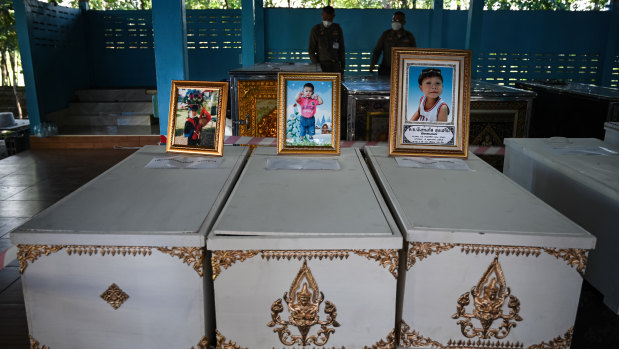 Portraits of victims sit atop coffins at Wat Si Uthai temple in north-east Thailand.