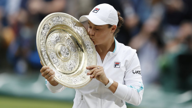 Ash Barty kisses the Wimbledon trophy after ending the 41-year drought for Australian women at the tournament.