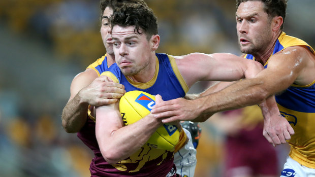Lachie Neale is tackled during the round 23 match between the Brisbane Lions and the West Coast Eagles at the Gabba.