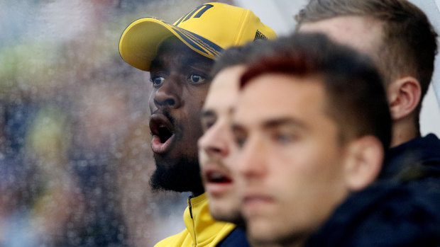 Support: Usain Bolt reacts from the dugout at Maitland Sports Ground.