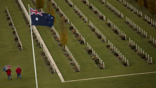 Two visitors walk among the headstones at the World War I Australian National Memorial in Villers-Bretonneux, France.