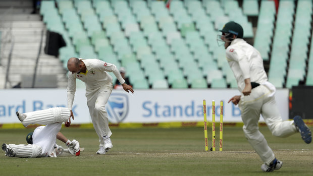 Charged by referee: Nathan Lyon drops the ball in the direction of de Villiers.