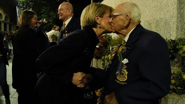 Foreign Minister Julie Bishop kisses Cenotaph custodian Wally Scott-Smith after completing his 78th Anzac Day dawn service at The Cenotaph in Martin Place.