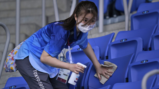 Selfless: A volunteer cleans the seats at the venue hosting tennis in Tokyo, in a typical gesture at these Games.