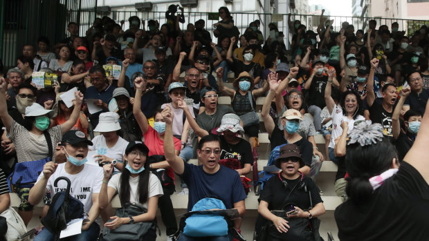Protesters pumped their fists as they chanted slogans in the stands of the soccer field at Southorn Playground in Wan Chai, Hong Kong.