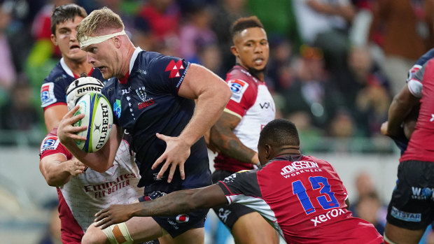Matt Philip makes some hard metres for the Rebels against the Lions at AAMI Park.