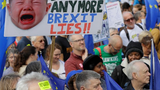 Anti-Brexit demonstrators carry placards and EU flags in London on Saturday.