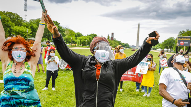 Supporters cheer after it’s announced that the United States will support the waiver at the Rally for Vaccine Access for Everyone, Everywhere in Washington, DC. 