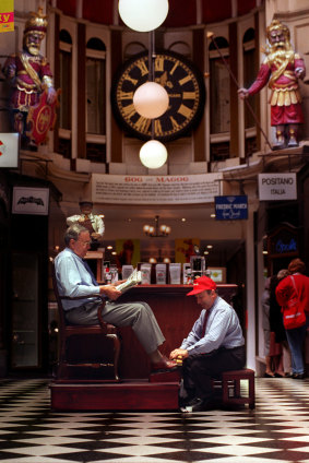 A man gets a shoe polish during lunchtime in the arcade in 1999.