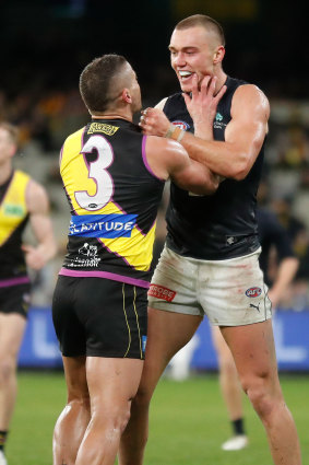 Dion Prestia and Patrick Cripps clash at three-quarter-time.