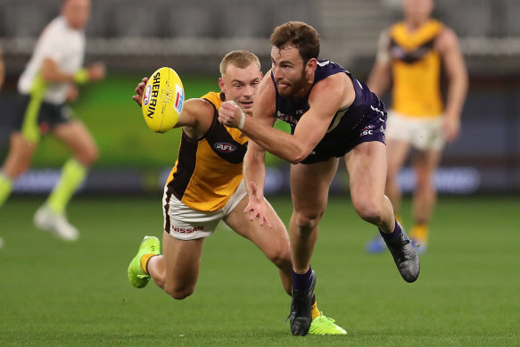 Connor Blakely gets a handball away for Fremantle.