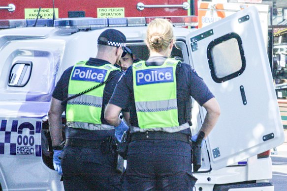 Police detain Brendan Nugent after the alleged attack.