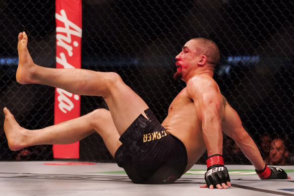 Australian Robert Whittaker goes down after being hit. 