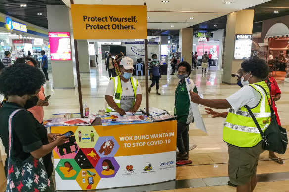 A stand distributes COVID-19 information at a shopping centre in Port Moresby.