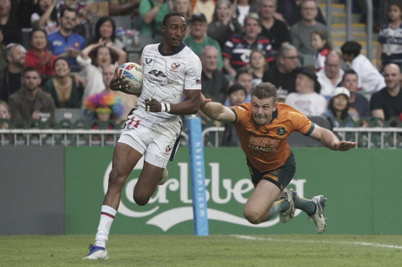 Perry Baker of the US breaks away from Australia’s Hayden Sargeant to score.