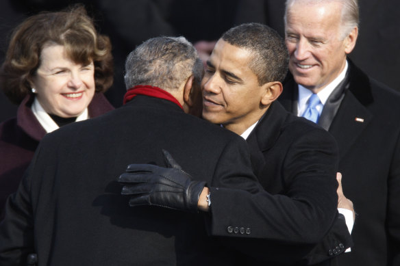 Dianne Feinstein and Joe Biden watch on during former president Barack Obama’s inauguration as he embraces civil rights leader Reverend Joseph E. Lowery 
