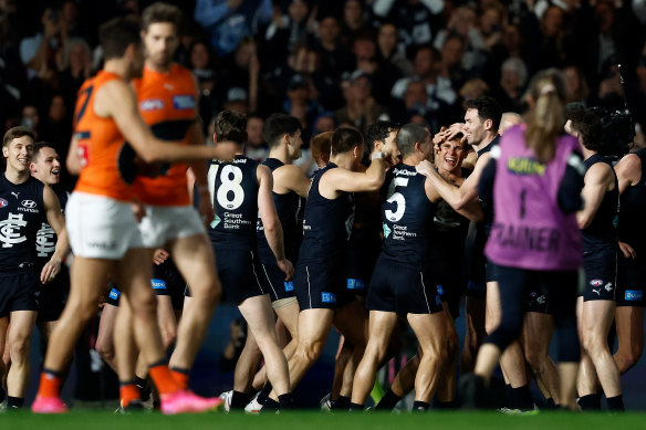 Blues sharpshooter Charlie Curnow is mobbed by teammates after securing the Coleman Medal.