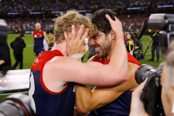 Demons stars Clayton Oliver and Christian Petracca celebrate their drought-breaking flag win.