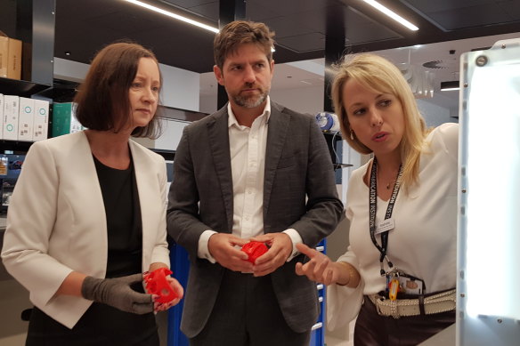 Health Minister Yvette D’Ath (left) with institute clinical director Michael Wagels and general manager Mathilde Desselle.