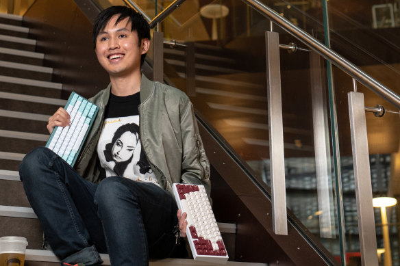 William Pham poses for a portrait with his unique keyboards.