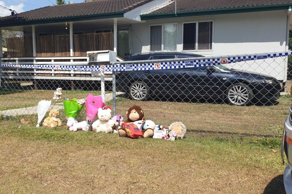 The Logan community left flowers and toys in honour of the two girls who died. 