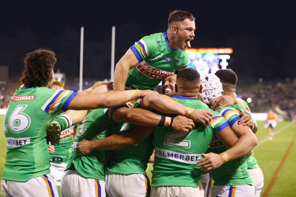 The Raiders celebrate a try by Albert Hopoate on Saturday night.