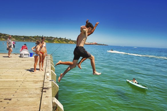 Beachgoers take the plunge at Frankston beach on Saturday.