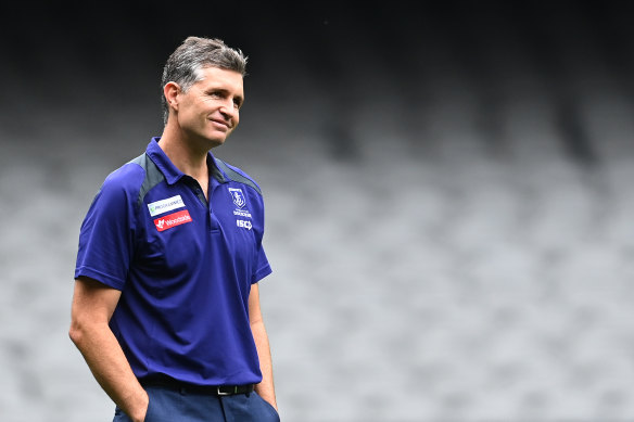 Dockers coach Justin Longmuir will miss the derby against the West Coast Eagles on Sunday after going into health and safety protocols.