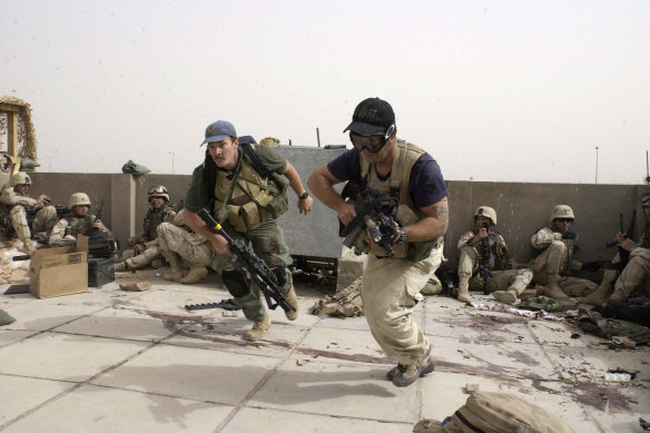 Plainclothes contractors working for Blackwater take part in a firefight in Iraq. 