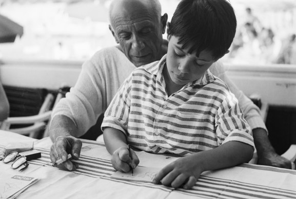 Pablo Picasso gives his young son Claude some instruction in the rudiments of sketching and painting, 1955.