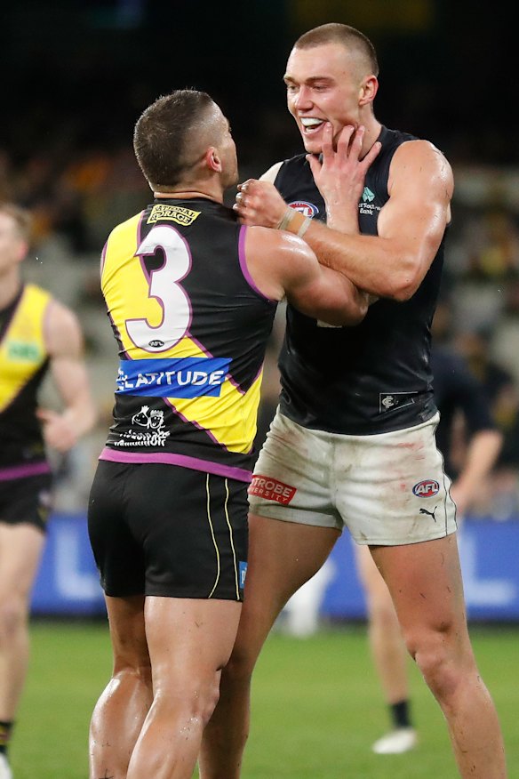Dion Prestia and Patrick Cripps clash at three-quarter-time.