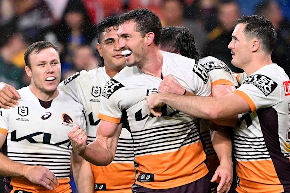 The Broncos celebrate one of Corey Oates’ two tries.