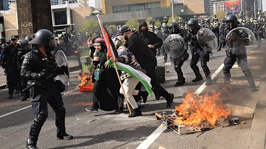 Fires burn during anti-war protests in Melbourne.