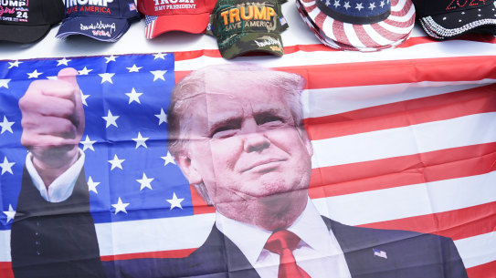 Merchandise is for sale on a table before Republican presidential candidate former president Donald Trump.